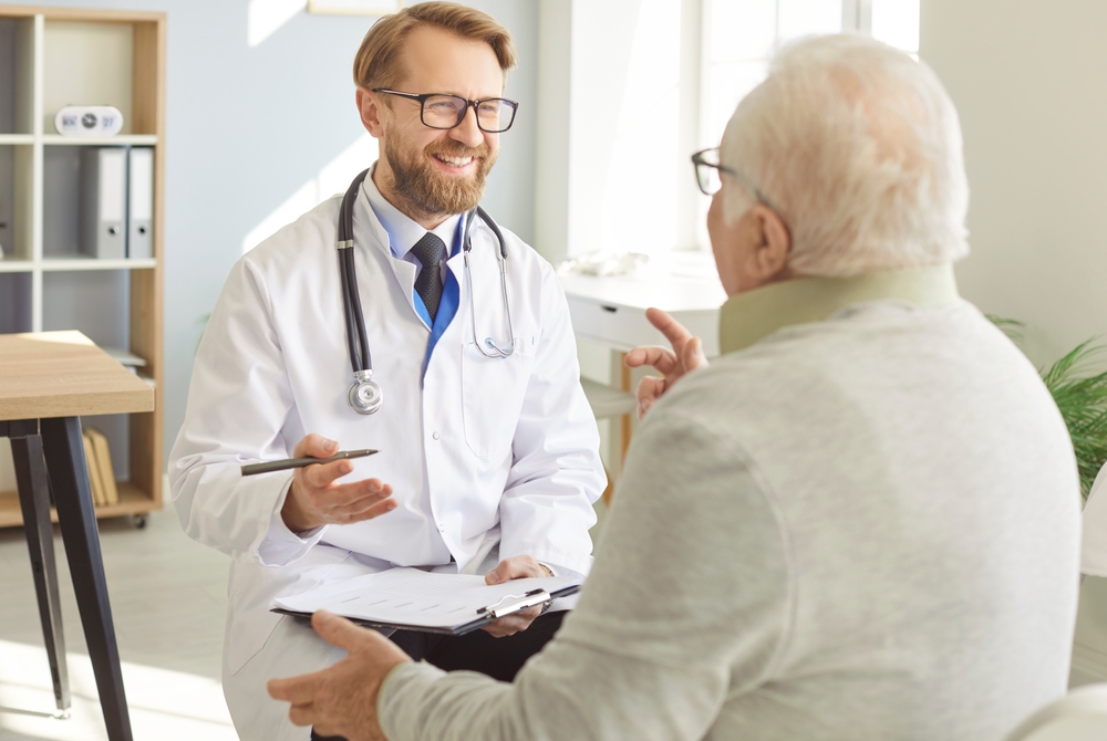 Positive,Skilled,Male,Doctor,Going,Through,Medical,Records,With,His